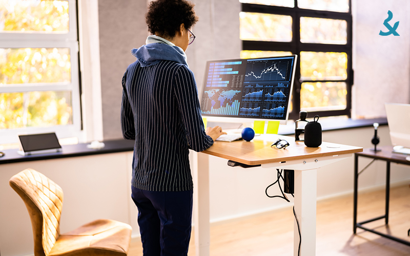 Person working on computer using a standing desk